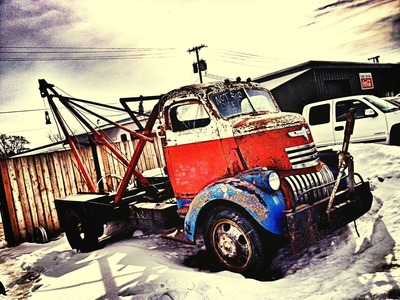 transportation, mode of transport, land vehicle, abandoned, car, obsolete, built structure, building exterior, stationary, outdoors, day, damaged, architecture, no people, sky, sunlight, construction site, old, street, run-down