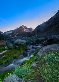 Scenic view of waterfall against sky