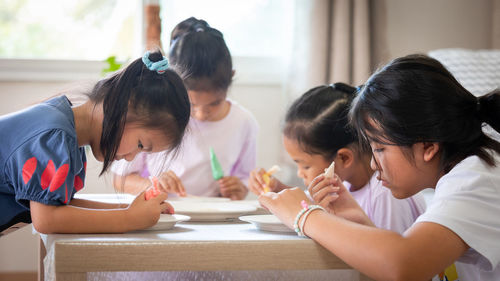 Kids decorating cookies at home