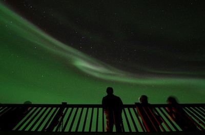 Low angle view of man standing against sky at night