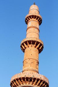 Low angle view of tower against blue sky