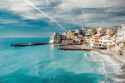 Scenic view of sea and buildings against sky