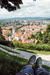 Low section of person against buildings in city