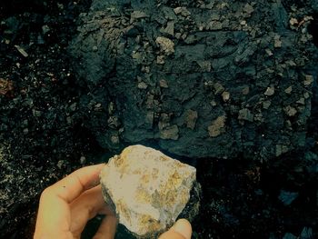 Midsection of person holding rock