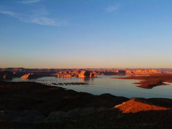 Scenic view of landscape against clear sky during sunset