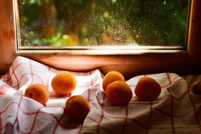 Close-up of fruits on glass window at home