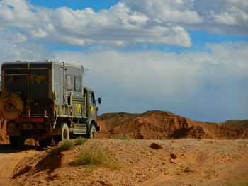 Cars on mountain against sky