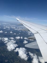 Aerial view of aircraft wing against sky