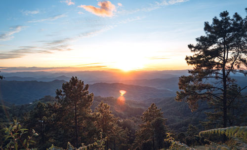 Scenic view of mountains against sky at sunset