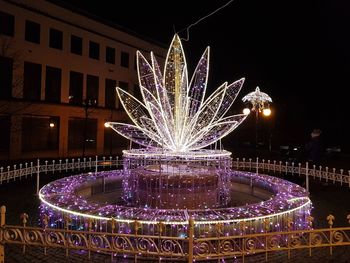 Illuminated firework display at night