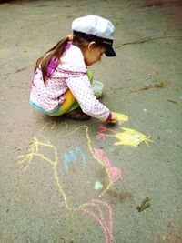 Girl drawing on walkway