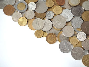 High angle view of coins on white background