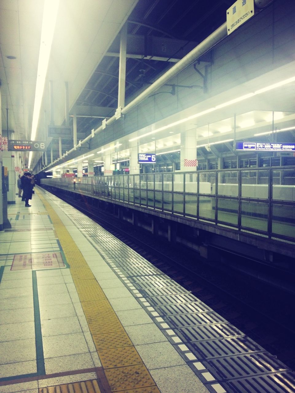 railroad station platform, railroad station, transportation, public transportation, rail transportation, indoors, railroad track, subway station, train - vehicle, travel, built structure, illuminated, subway, transportation building - type of building, architecture, incidental people, railway station, public transport, passenger train