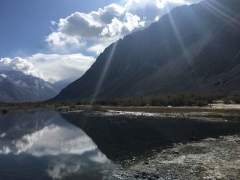 Scenic view of lake and mountains against sky