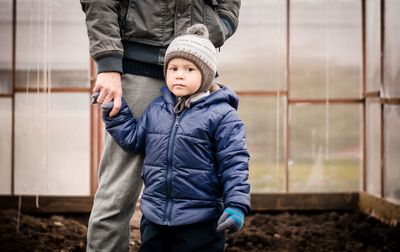 Portrait of boy standing with father