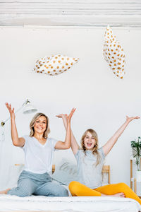 Happy friends sitting on floor