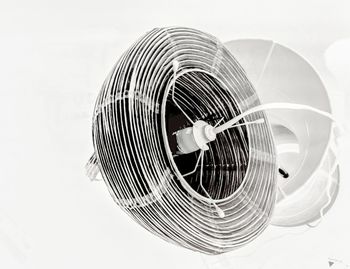 Close-up of electric fan against white background