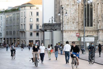 Group of people walking on city street