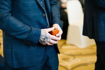 Midsection of man holding jewelry box