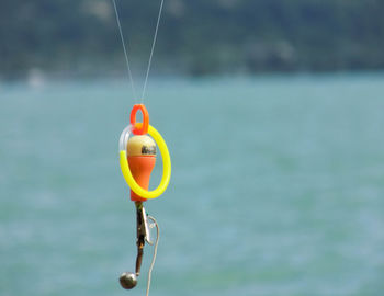 Close-up of toy against river on sunny day