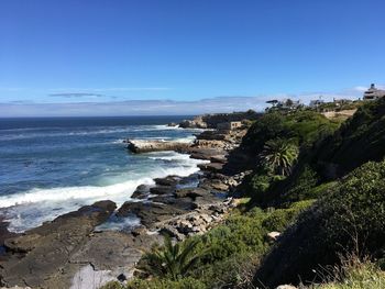 Scenic view of sea against blue sky