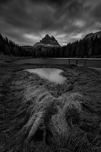 Scenic view of river against cloudy sky