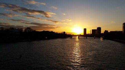 Scenic view of silhouette buildings against sky during sunset