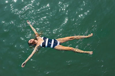 High angle view of woman swimming in sea