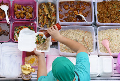 High angle view of woman serving food at market