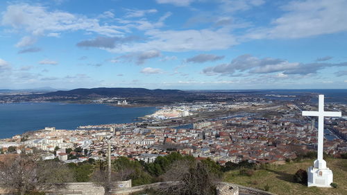 High angle view of townscape by sea against sky