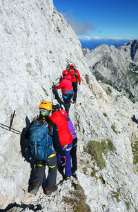 Rear view of hikers walking on mountain