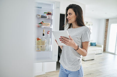 Full length of woman using mobile phone