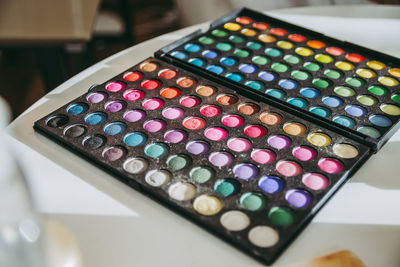 High angle view of multi colored makeup on table