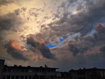 Low angle view of building against cloudy sky