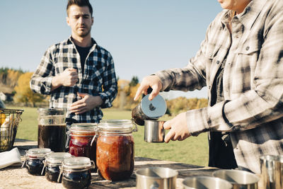 Man standing by food on table