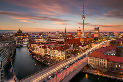 High angle view of illuminated city buildings during sunset