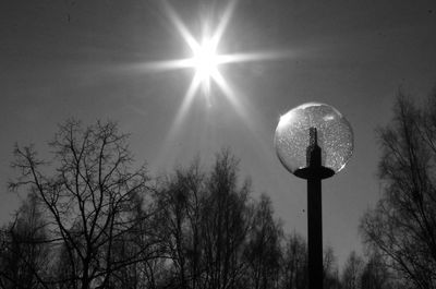 Low angle view of illuminated street light against sky