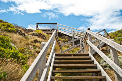 Steps leading towards mountain against sky