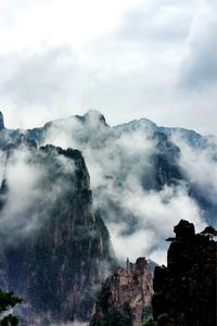 Scenic view of mountains surrounded by clouds