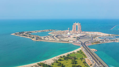 High angle view of sea and cityscape against sky