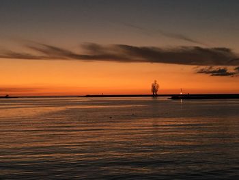 Scenic view of sea against orange sky