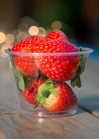 Close-up of strawberries in glass on table