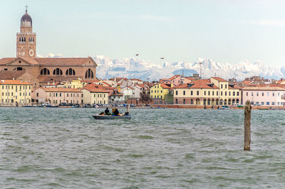 Canal amidst buildings in city