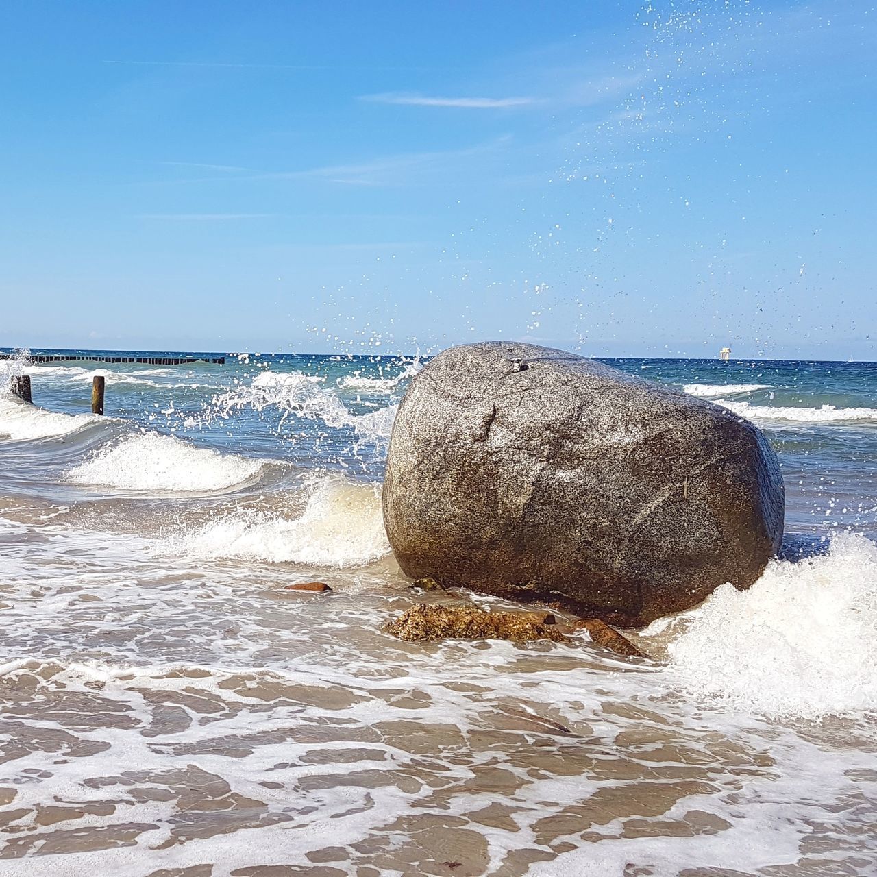 SCENIC VIEW OF SEA WAVES SPLASHING ON ROCKS