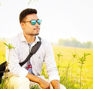 Mid adult man sitting on field