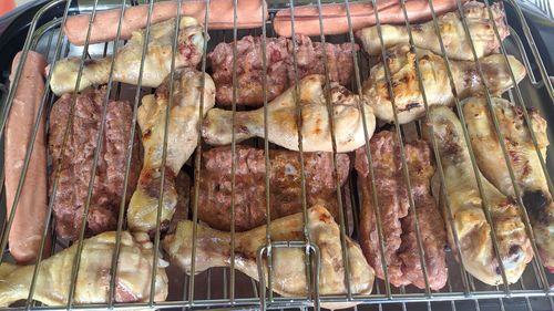 High angle view of meat on barbecue grill