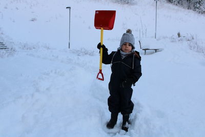 Portrait of boy  standing on snow