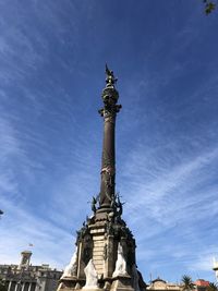 Low angle view of statue of liberty against blue sky