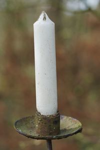 Close-up of candle on metal