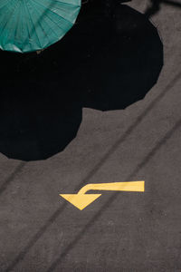 High angle view of arrow sign on road